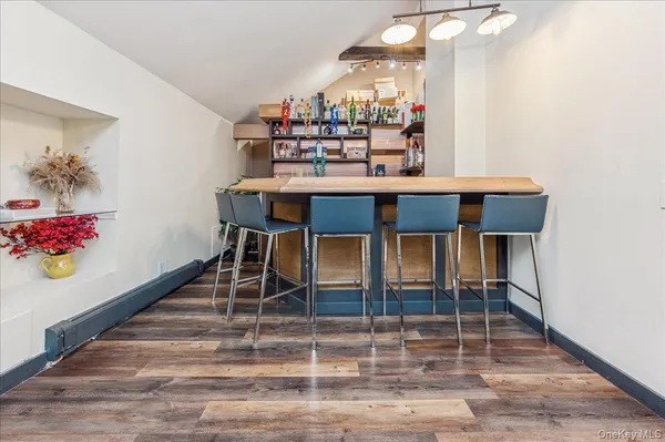a dining room with furniture and wooden floor