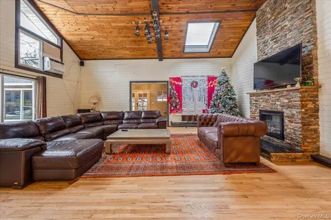 a living room with furniture fireplace and flat screen tv