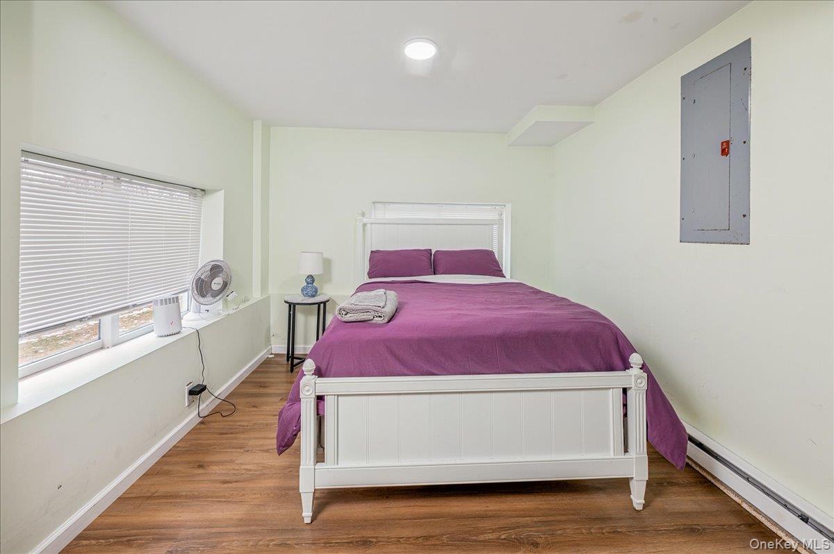 584 Milltown Road Brewster, NY 10509 - Photo 27 of 37 a living room with a bed and a window