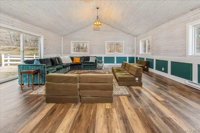 a living room with furniture a fireplace and a table
