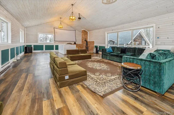 a living room with furniture a rug and a table