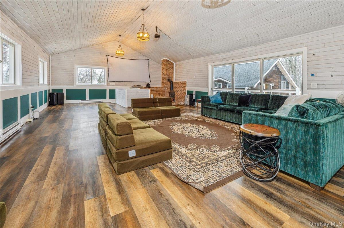 584 Milltown Road Brewster, NY 10509 - Photo 32 of 37 a living room with furniture a rug and a table