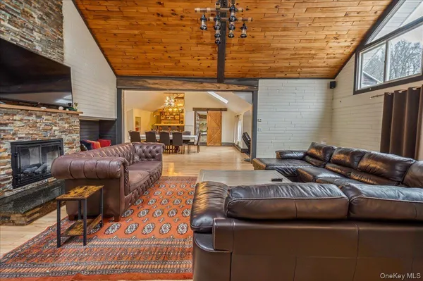 a living room with furniture fireplace and flat screen tv