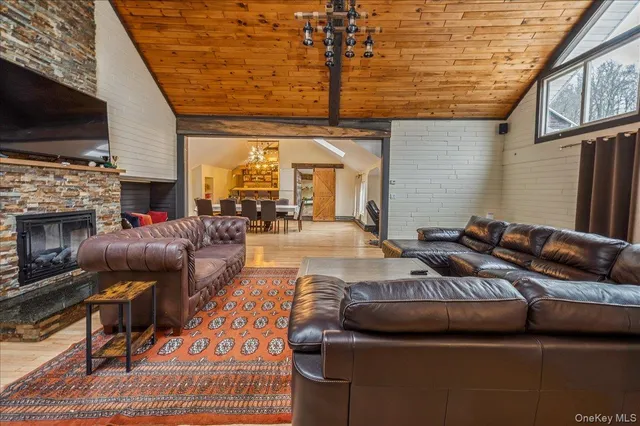 a living room with furniture fireplace and flat screen tv
