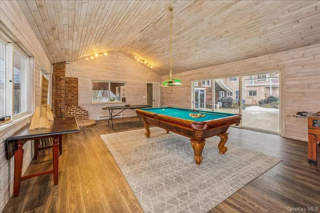 a living room with furniture a table and wooden floor