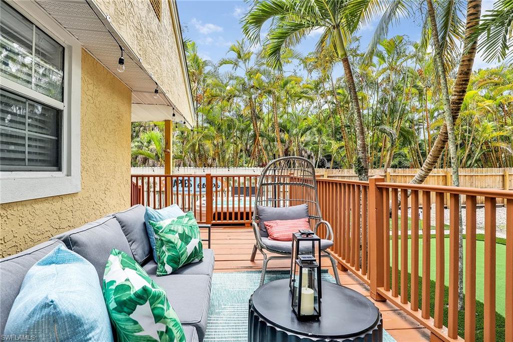 2780 Weeks Avenue Naples, FL 34112 - Photo 24 of 34 a balcony with chairs and a potted plant