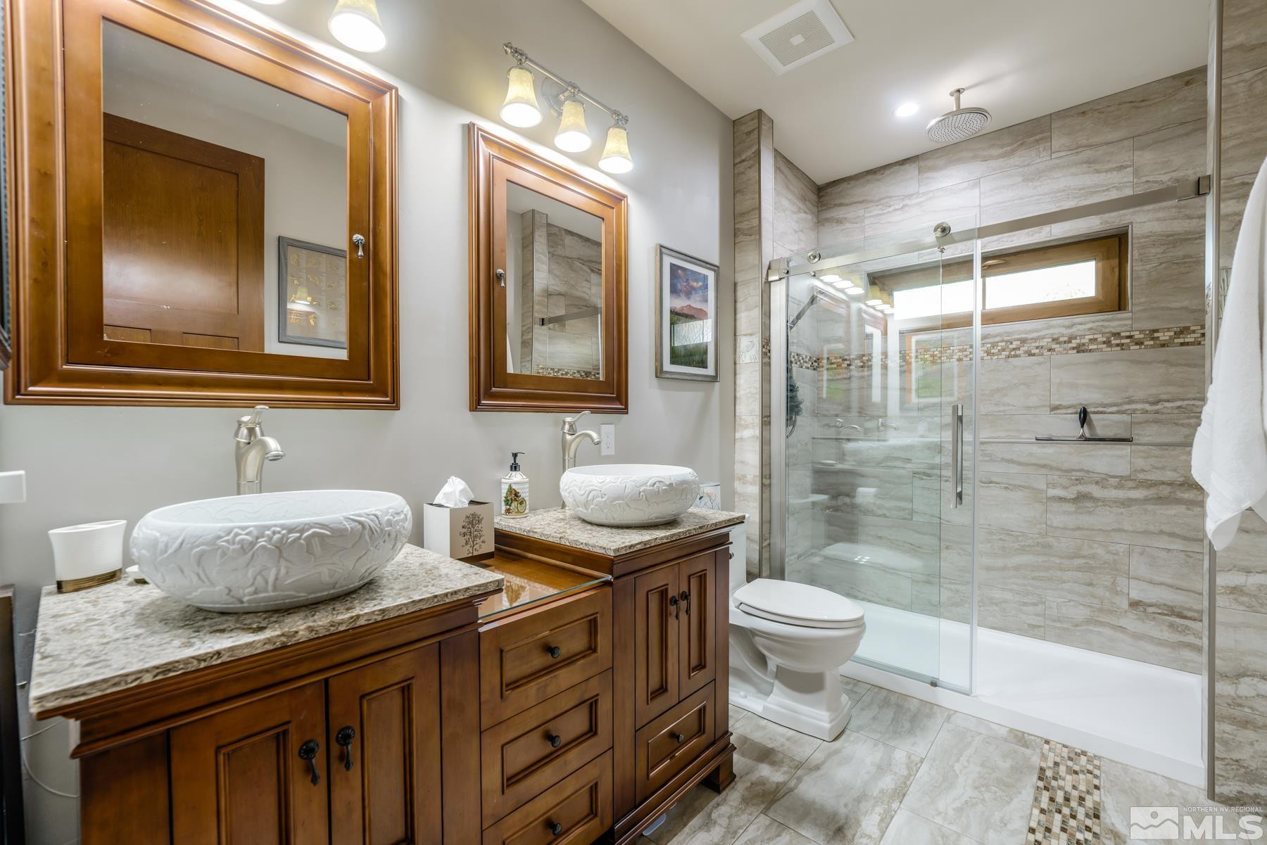 2785 West Lakeridge Reno, NV 89519 - Photo 24 of 40 a bathroom with a granite countertop toilet sink and mirror
