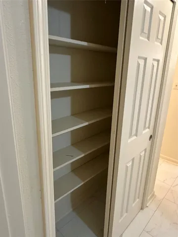 a view of a closet with wooden floor