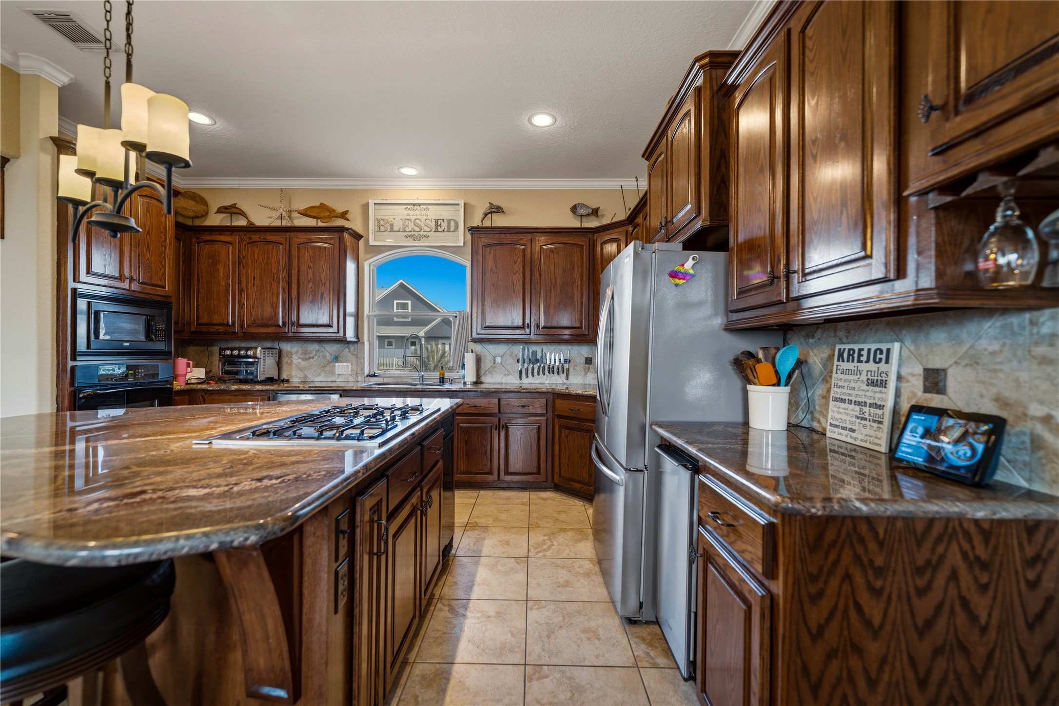 8 Loggerhead Hitchcock, TX 77563 - Photo 5 of 25 a kitchen with stainless steel appliances granite countertop a sink stove and refrigerator