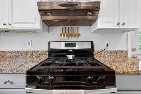 a stove top oven sitting inside of a kitchen