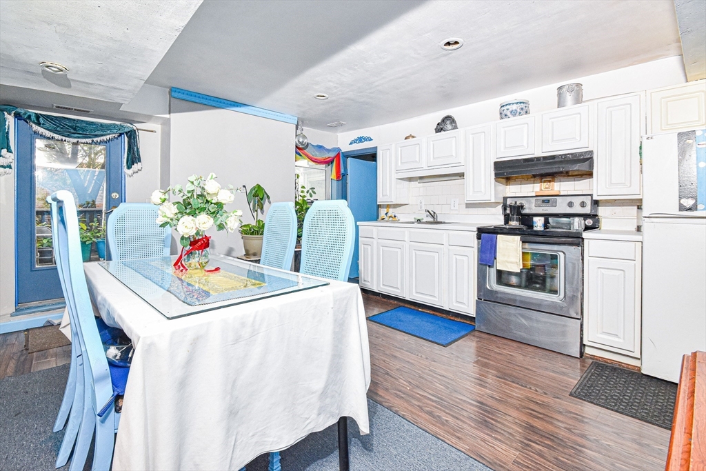 61 Webster Street, Unit 3 Boston, MA 02128 - Photo 2 of 20 a kitchen that has a lot of white cabinets and stainless steel appliances