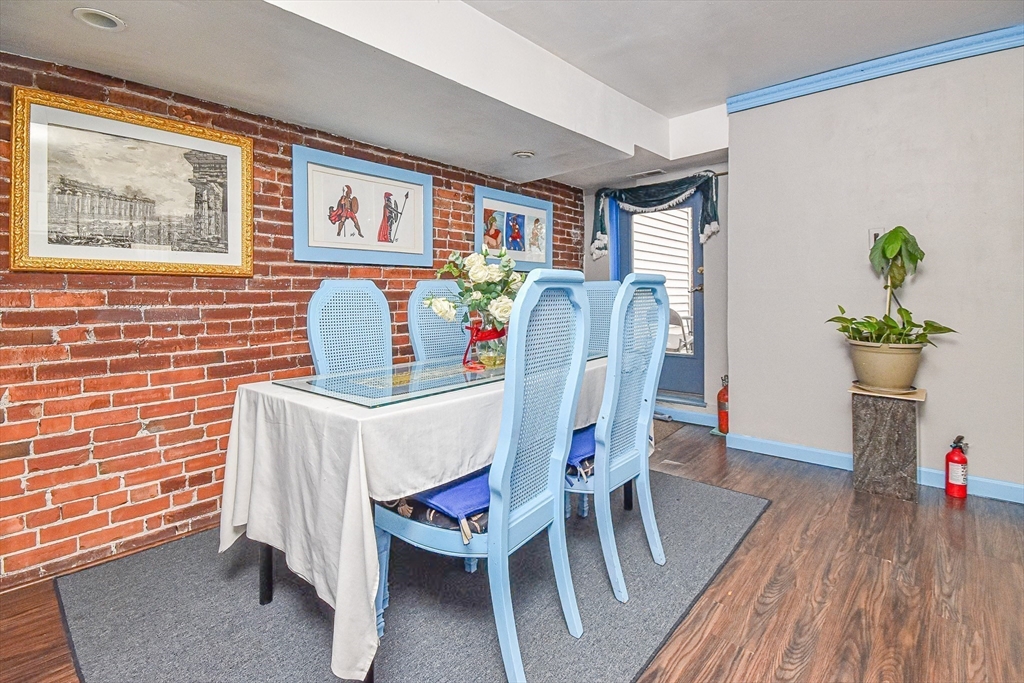 61 Webster Street, Unit 3 Boston, MA 02128 - Photo 3 of 20 a dining room with furniture a rug and wooden floor
