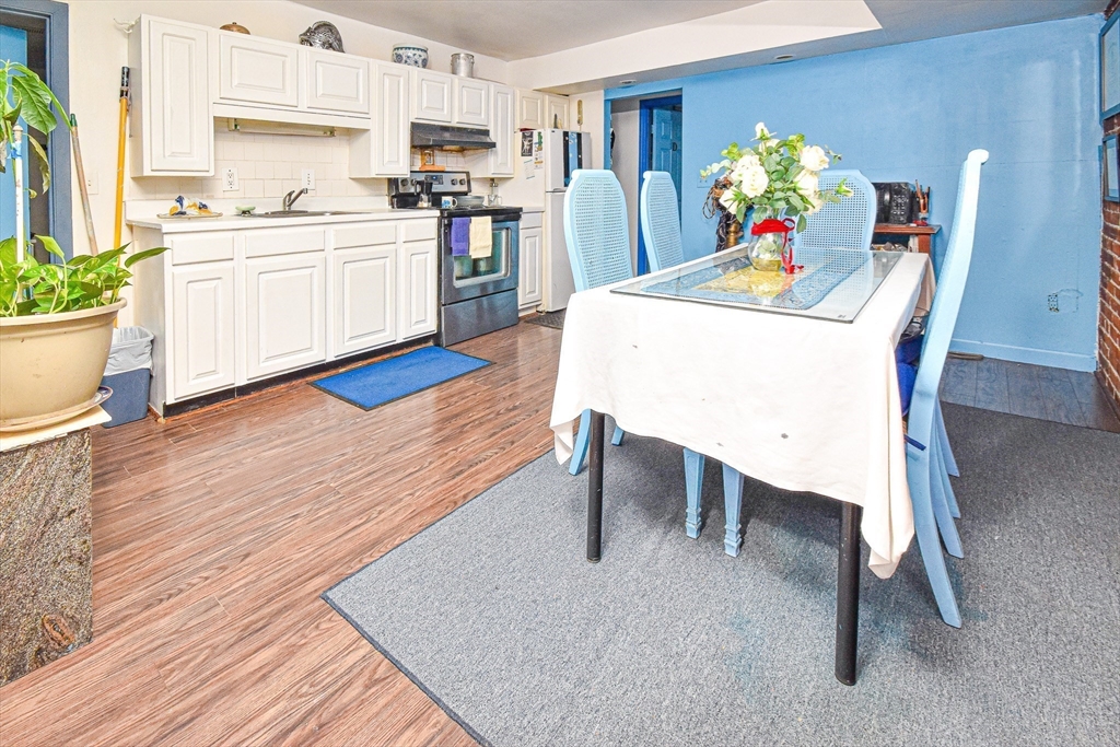 61 Webster Street, Unit 3 Boston, MA 02128 - Photo 5 of 20 a kitchen with granite countertop sink cabinets and stainless steel appliances