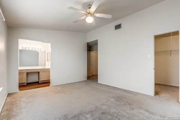 a view of an empty room with a fireplace and a window