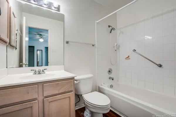 a bathroom with a sink toilet vanity and shower