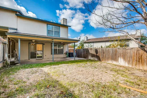 a view of a house with backyard porch and sitting area