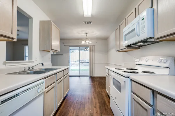 a kitchen with stainless steel appliances granite countertop a sink stove and cabinets