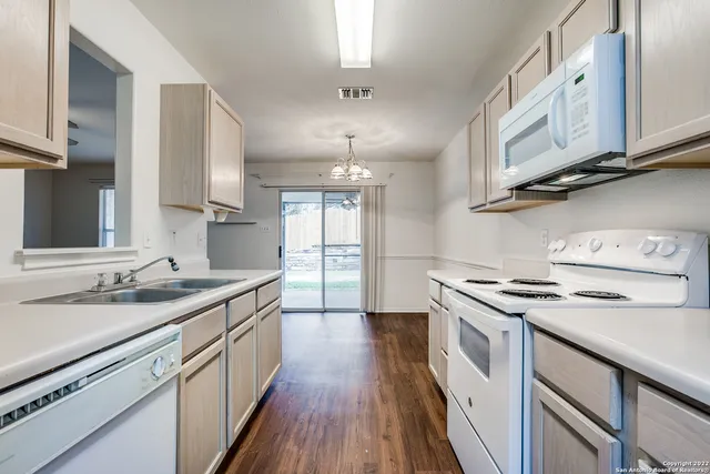 a kitchen with stainless steel appliances granite countertop a sink stove and cabinets