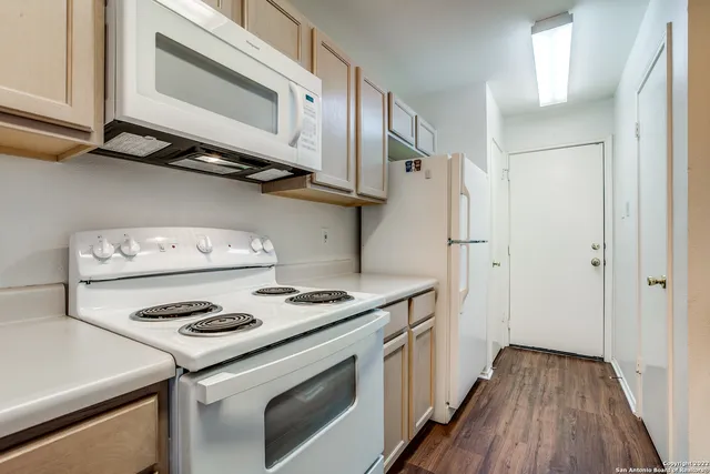 a kitchen with a stove and a microwave