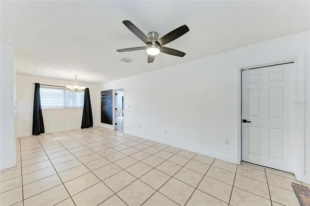 a view of a livingroom with a ceiling fan and window
