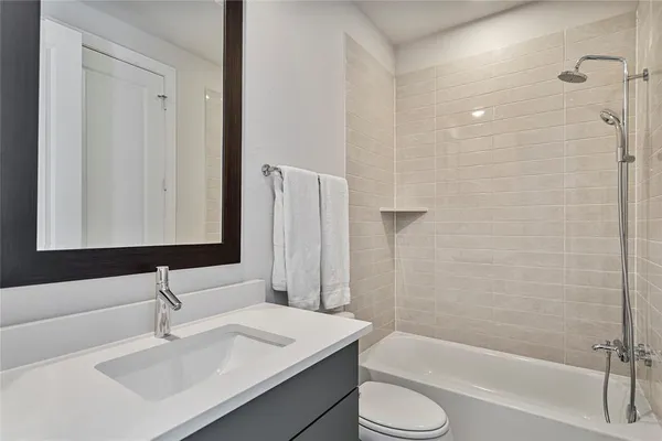 a bathroom with a sink toilet and shower