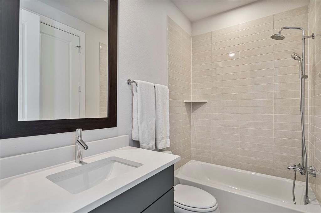 2157 Wenge Lane Dallas, TX 75219 - Photo 14 of 26 a bathroom with a sink toilet and shower