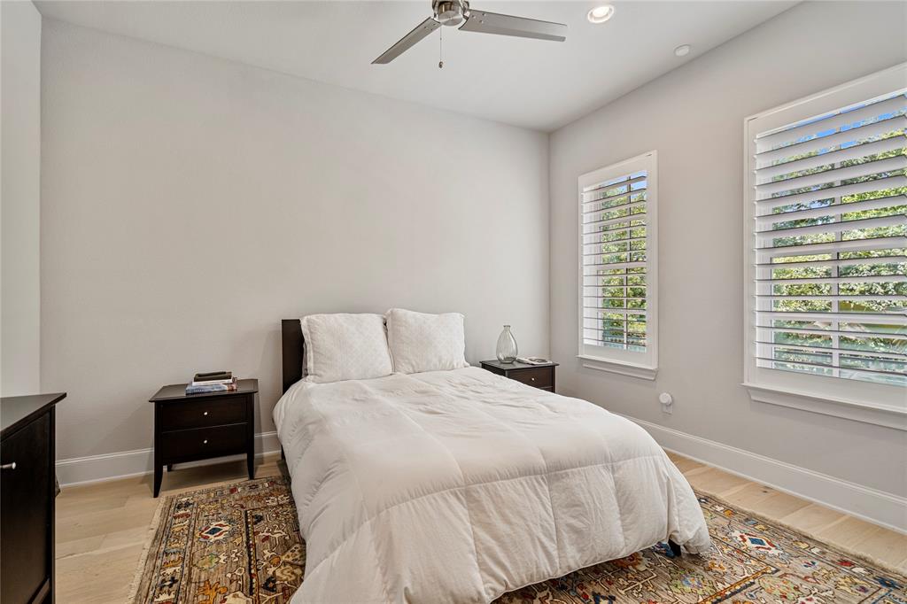 2157 Wenge Lane Dallas, TX 75219 - Photo 15 of 26 a bedroom with a bed and wooden floor