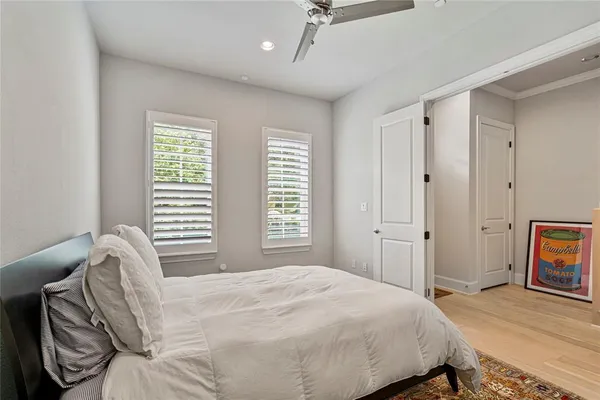 a bedroom with a bed and a window