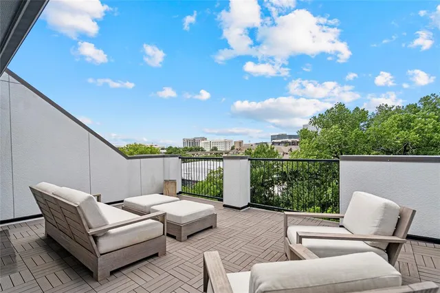 a view of a patio with couches chairs and potted plants