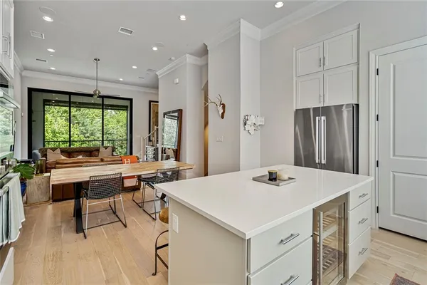 a kitchen with a table chairs and wooden floor