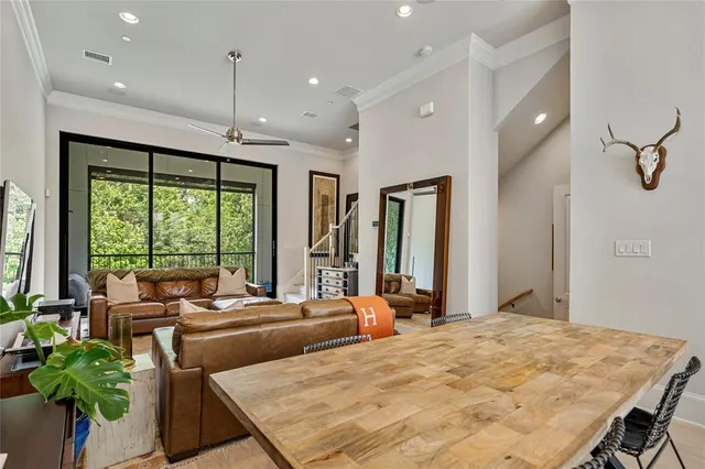 a bedroom with a large bed and a potted plant
