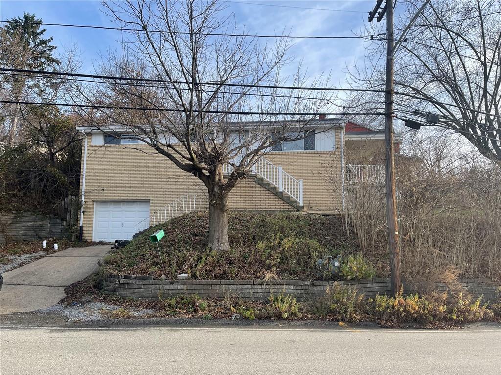 a tree in the house next to a yard