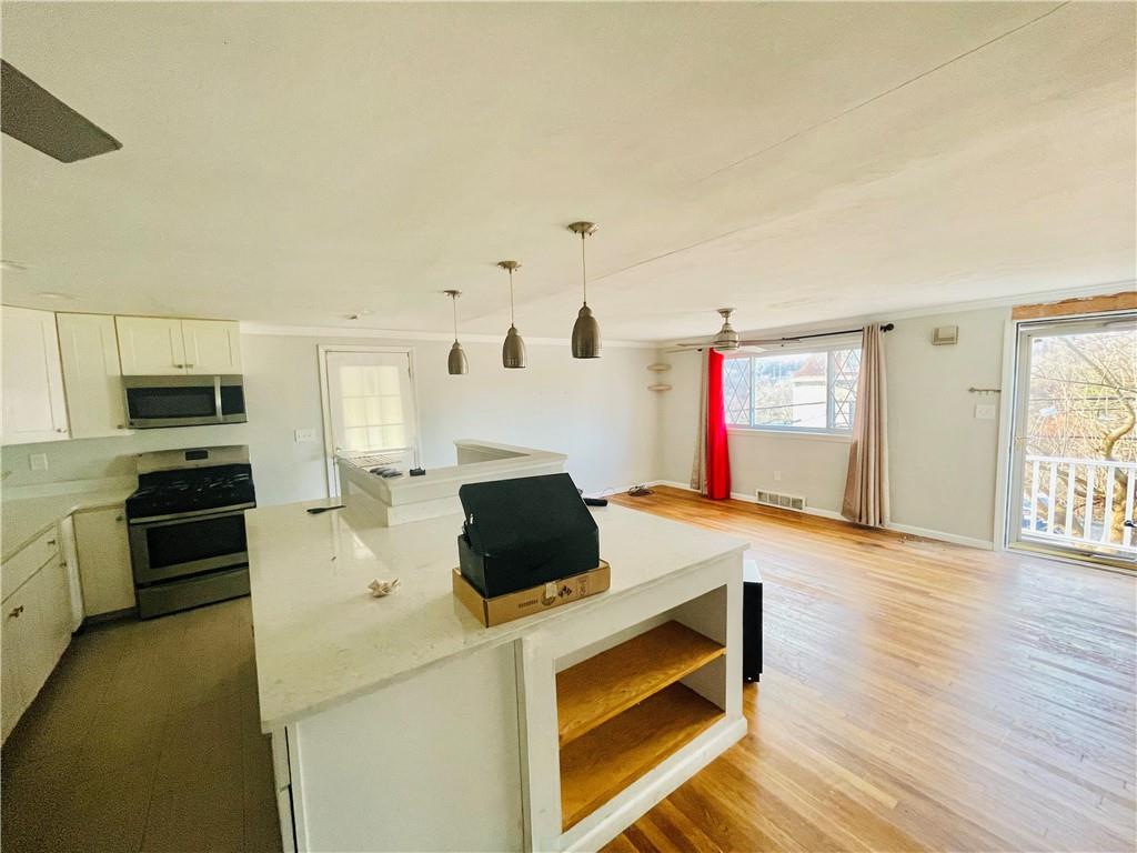 2720 Mt Troy Road Pittsburgh, PA 15212 - Photo 11 of 15 a kitchen with stainless steel appliances kitchen island wooden cabinets and stove