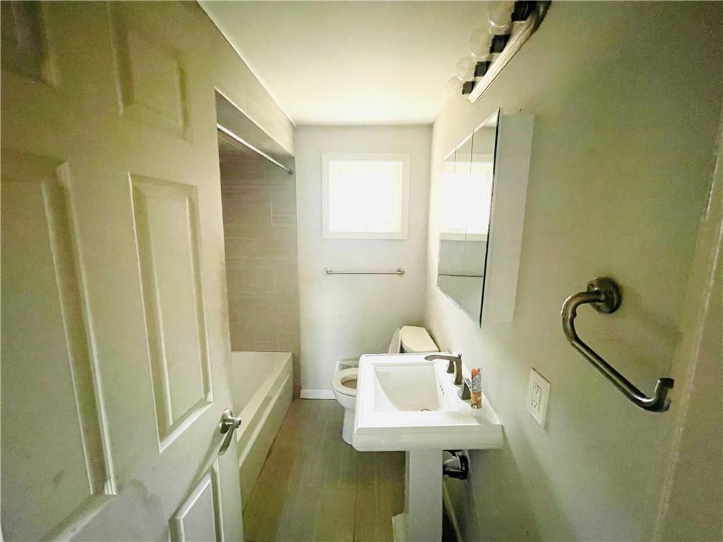 2720 Mt Troy Road Pittsburgh, PA 15212 - Photo 9 of 15 a bathroom with a sink a toilet and shower