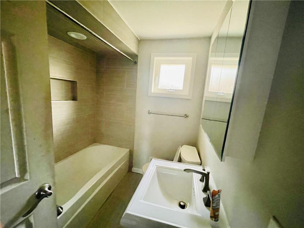 2720 Mt Troy Road Pittsburgh, PA 15212 - Photo 10 of 15 a bathroom with a sink a toilet and shower