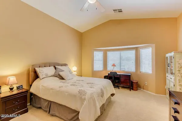 a bedroom with a bed and a desk