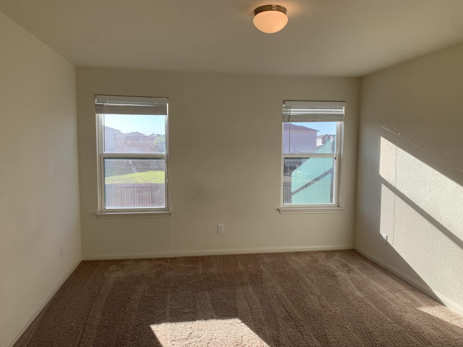 217 Denson Lane Jarrell, TX 76537 - Photo 14 of 26 Plush carpeting and two windows with blinds