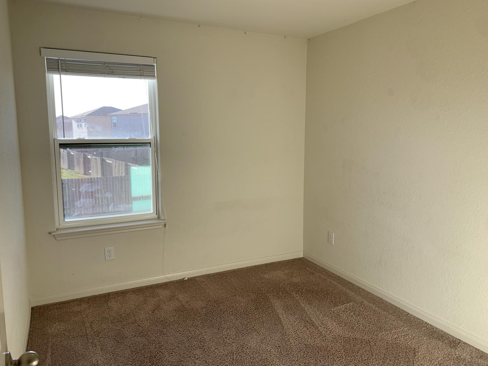 217 Denson Lane Jarrell, TX 76537 - Photo 19 of 26 Carpeted room featuring a single window with blinds and textured walls