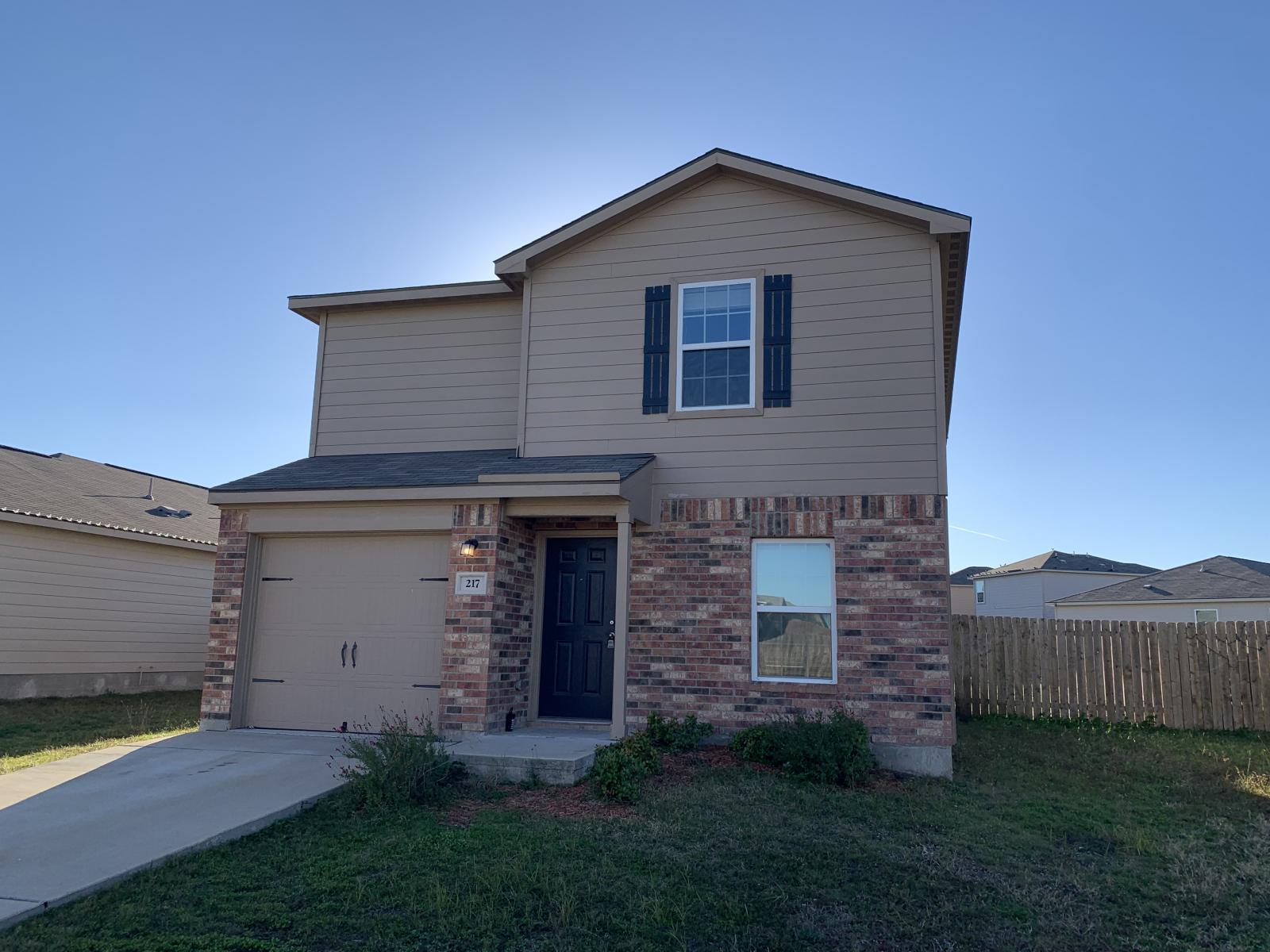 217 Denson Lane Jarrell, TX 76537 - Photo 2 of 26 Two-story residence featuring a brick and siding facade