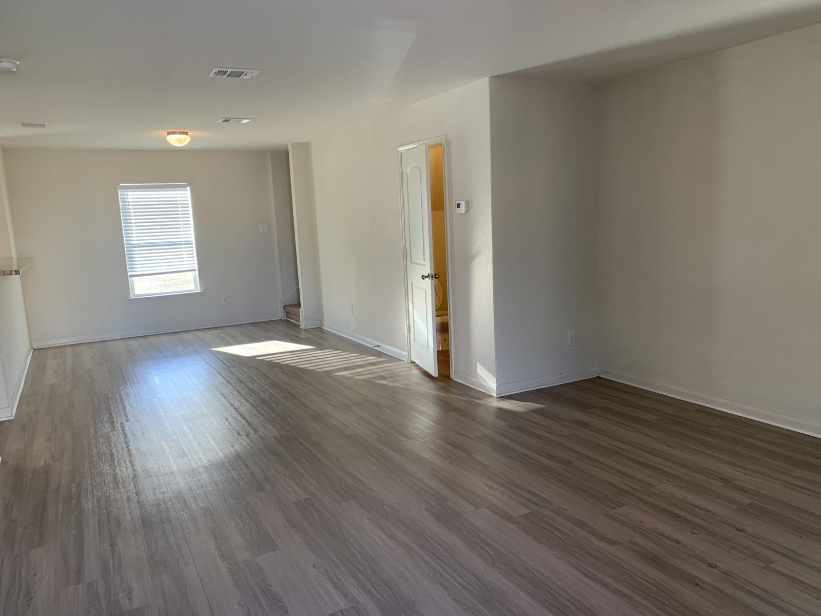 217 Denson Lane Jarrell, TX 76537 - Photo 24 of 26 Spacious room featuring wood-finish flooring, neutral wall tones, a single window with blinds, and recessed lighting
