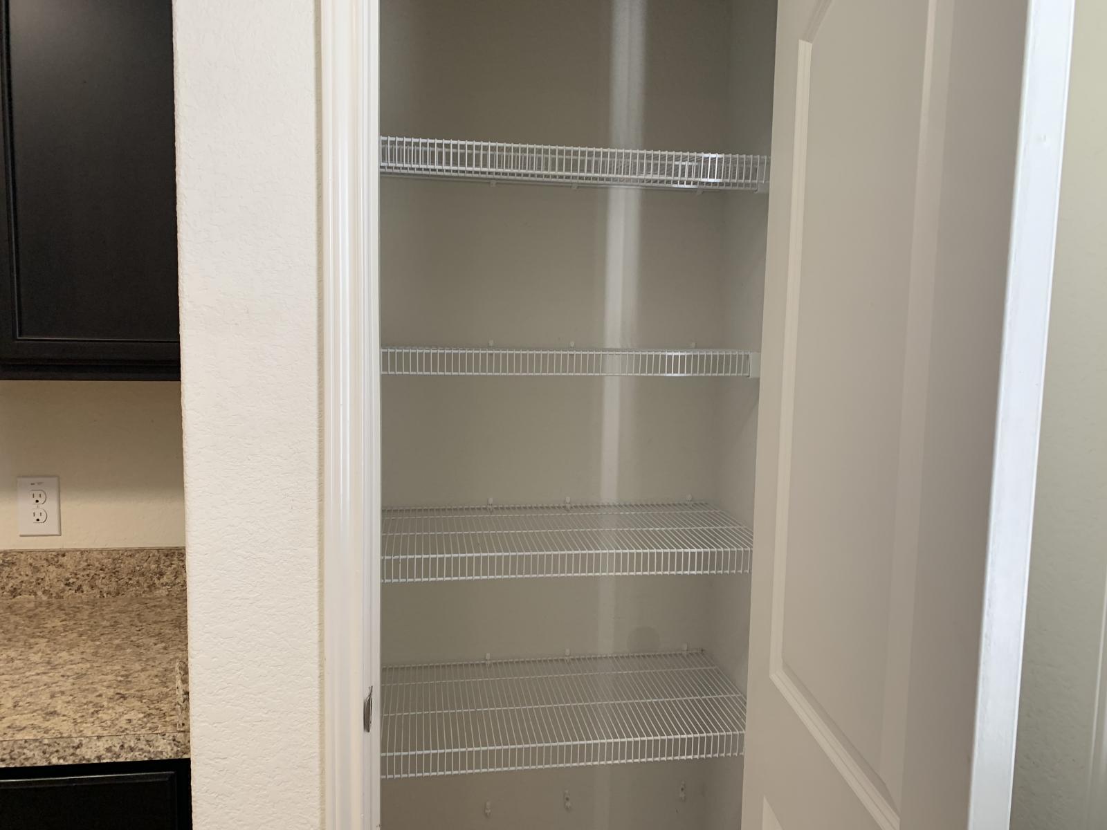 217 Denson Lane Jarrell, TX 76537 - Photo 6 of 26 Pantry featuring multiple wire shelves, a light-colored interior, and a white interior door