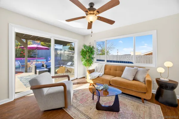 a living room with furniture and a potted plant
