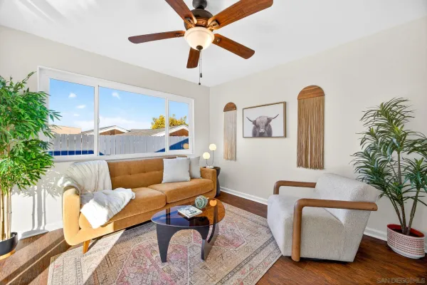 a living room with furniture or wooden floor and a chandelier