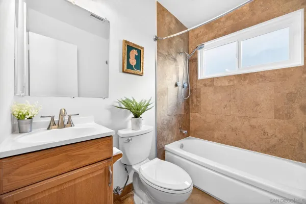 a white bath tub with a shower