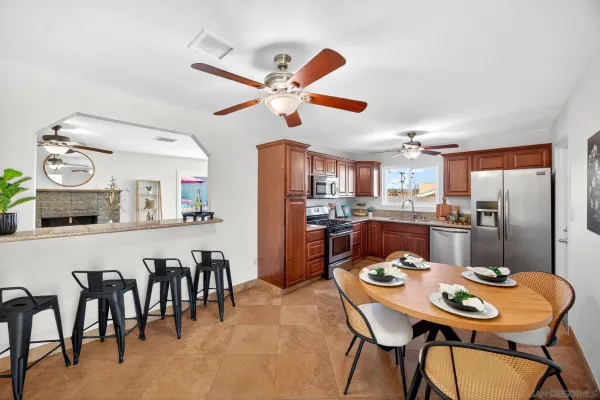 a kitchen with stainless steel appliances granite countertop a stove top oven a refrigerator a sink and dishwasher