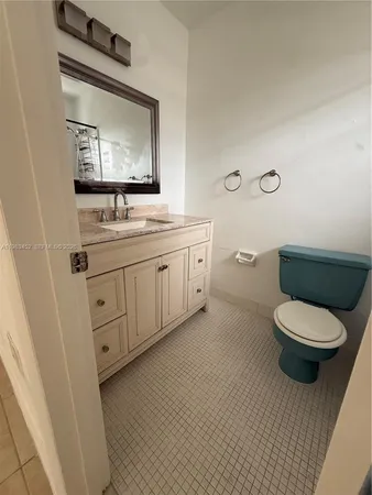 a bathroom with a toilet a sink and mirror