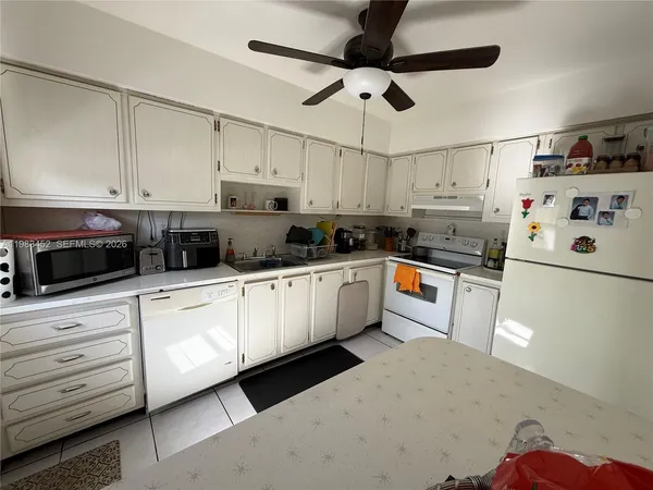 a kitchen with a table chairs and a refrigerator