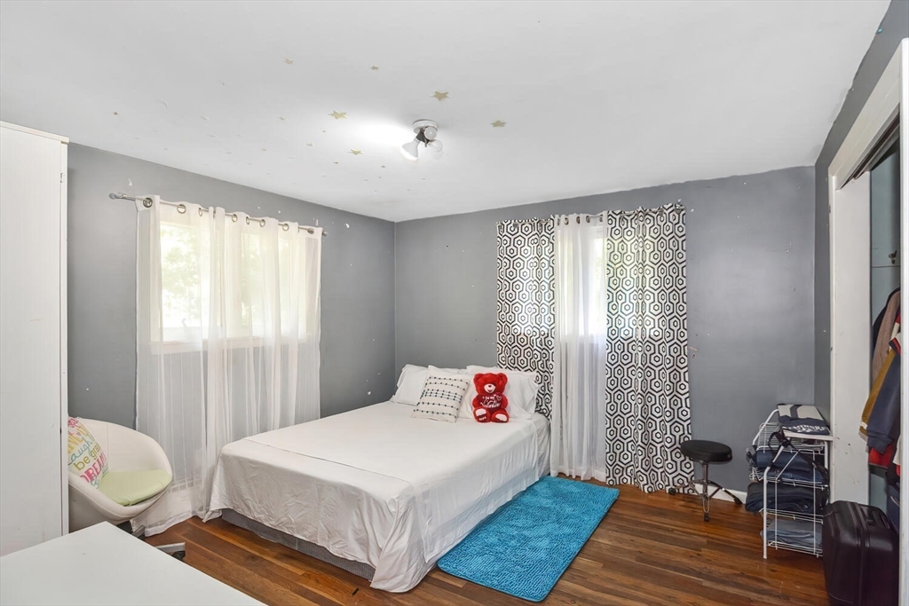 9 Flagg Drive Framingham, MA 01702 - Photo 14 of 22 a bedroom with a bed and wooden floor