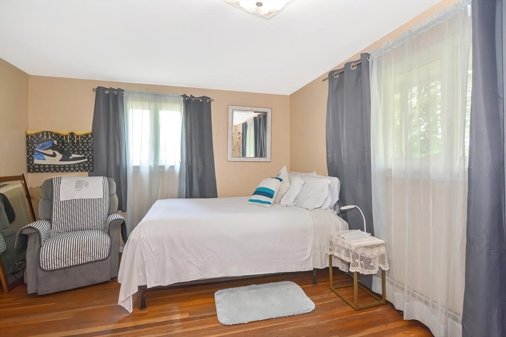 9 Flagg Drive Framingham, MA 01702 - Photo 15 of 22 a bedroom with a bed and wooden floor