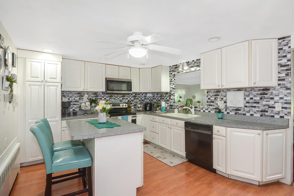 9 Flagg Drive Framingham, MA 01702 - Photo 3 of 22 a kitchen with granite countertop white cabinets and white appliances